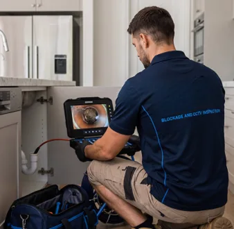 Clearing a blocked sink at a Moore Park property